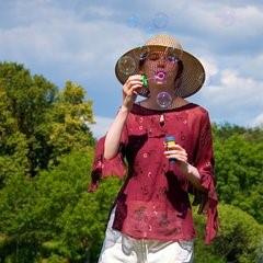 woman blowing bubbles