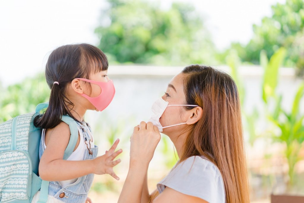 mom and daughter in face masks