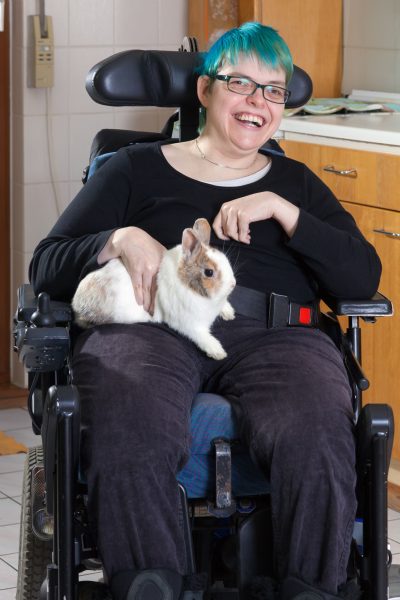 Image of a woman in a wheelchair petting a rabbit 